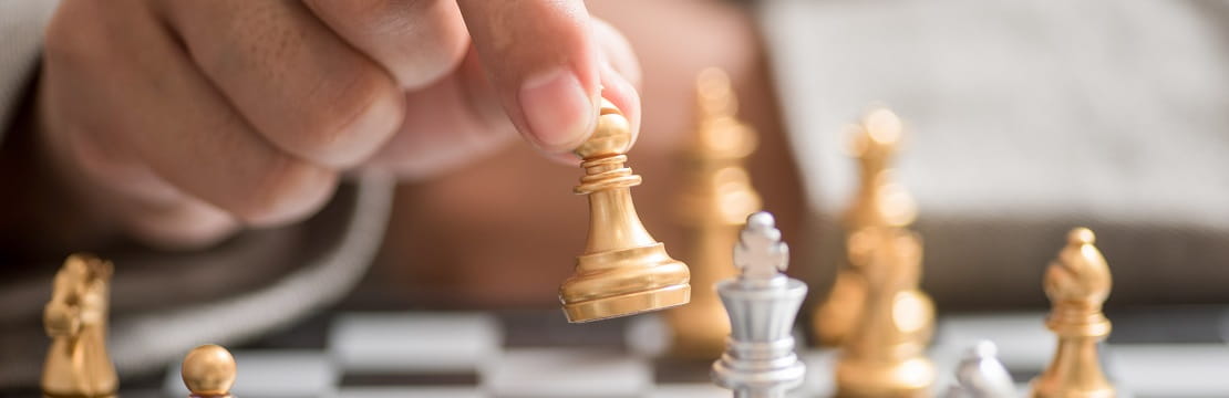 Businessman hand with businessman goal with chess